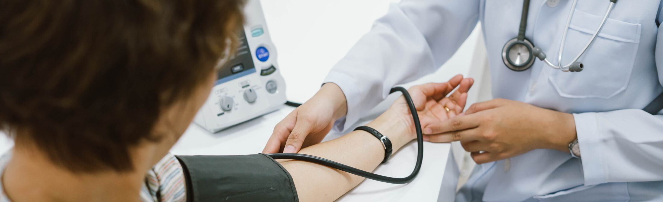 close up doctor checking senior patient blood pressure. Health c close up doctor checking senior patient blood pressure. Health care.
