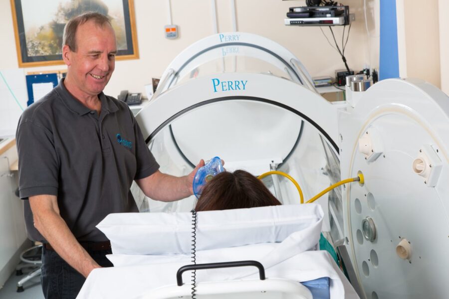 A patient being looked after in a mono place hyperbaric chamber