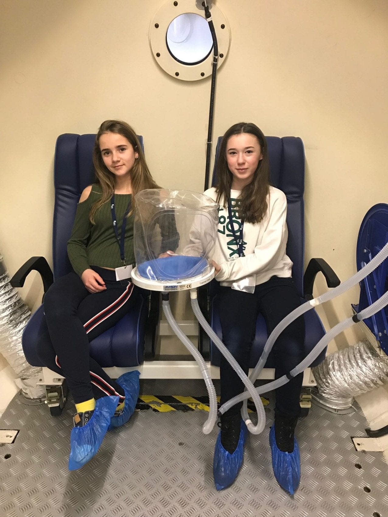 Fundraising girls inside the Krug hyperbaric chamber on a tour of DDRC