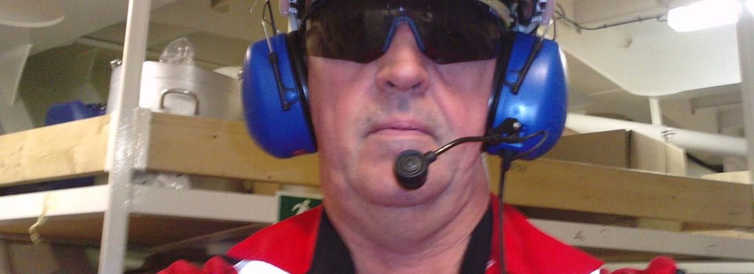Picture of John Adamson on rig with ear defenders