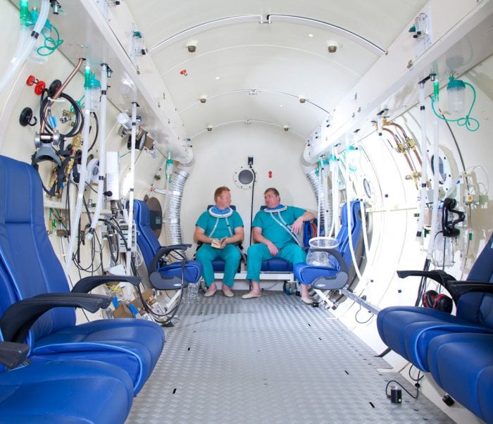 DDRC staff modelling as patients in the hyperbaric chamber